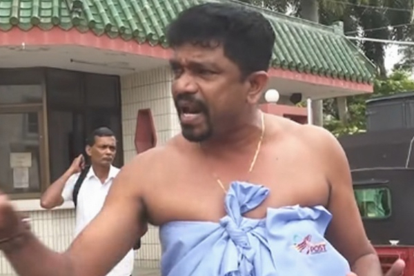 அரைகுறை ஆடையுடன் ஆர்ப்பாட்டத்தில் ஈடுபட்ட தபால் ஊழியரின் பின்னணி ; சபையில் வெளியான விடயம்